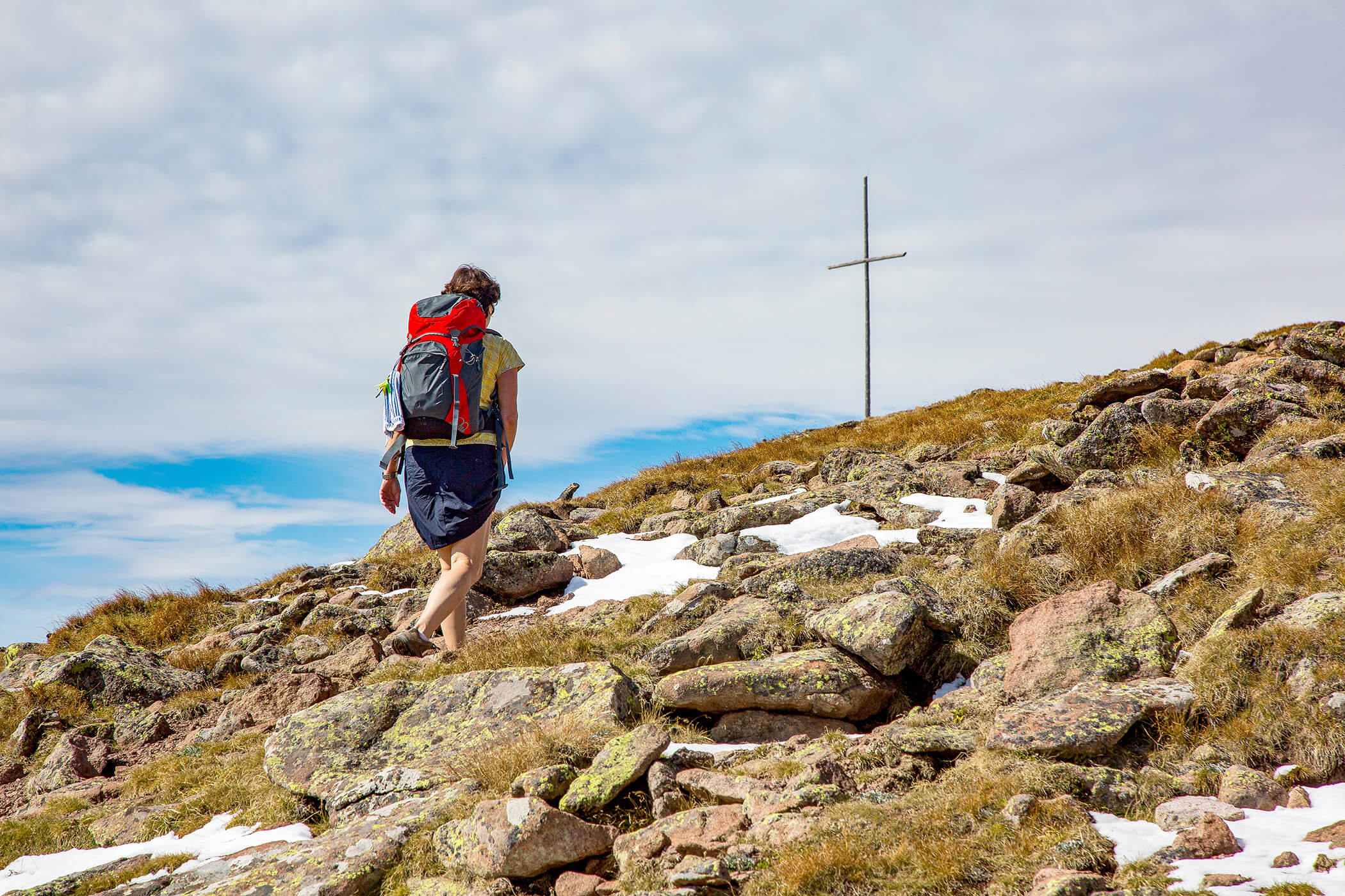Un'escursionista sulla via verso la croce sommitale